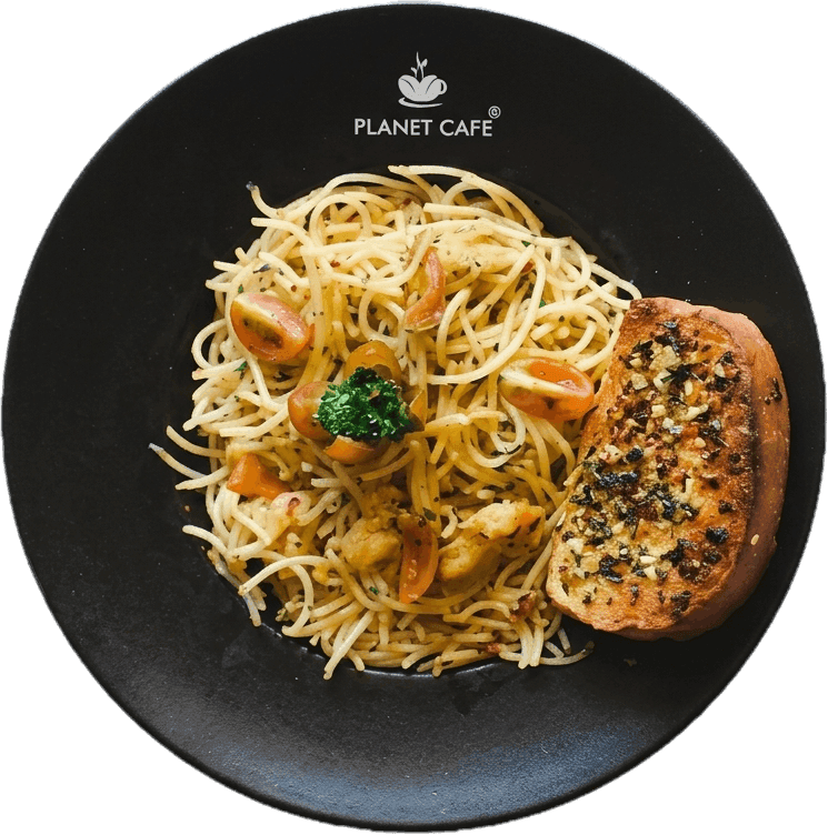 Planet Cafe signature pasta on a black plate with garlic bread